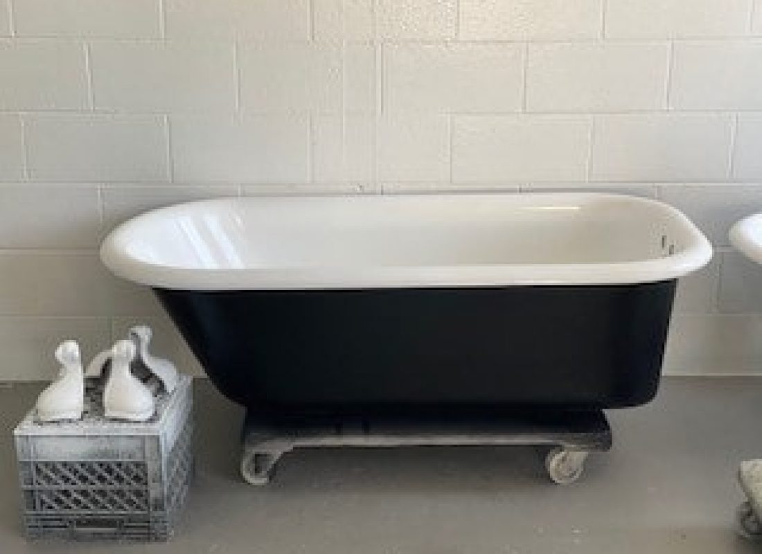 Experienced technician applying final coat to a bathtub in a modern Haverhill, MA apartment unit