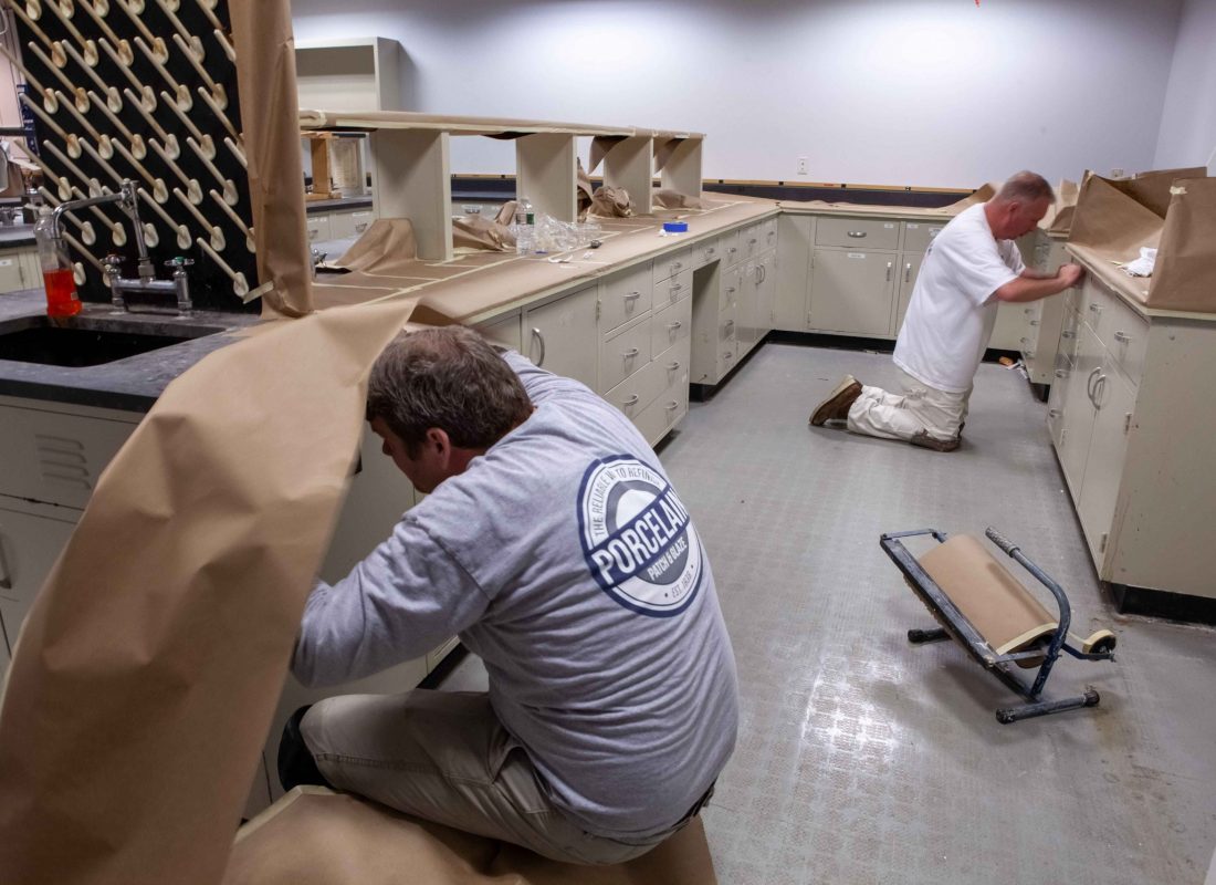 Porcelain Patch & Glaze team expertly applying coatings during a bathroom tub refinishing service in Middlesex County