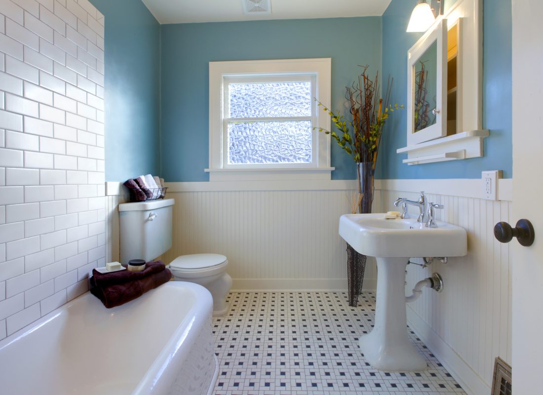 Technician refinishing a bathtub in a Haverhill, MA rental home for improved appearance and durability