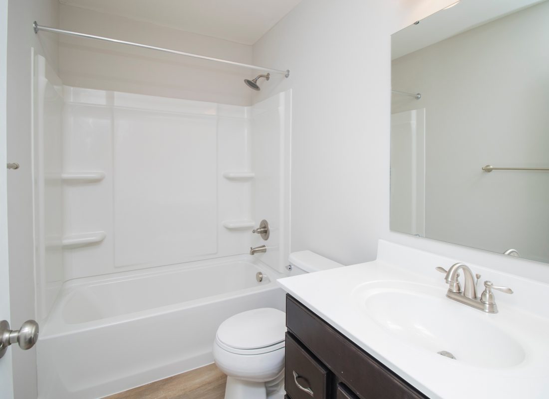Before and after of a bathtub makeover by Porcelain Patch & Glaze, showcasing expert refinishing skills