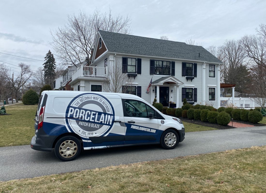 Expert technician from Porcelain Patch & Glaze performing professional bathroom tub refinishing in a Middlesex County home
