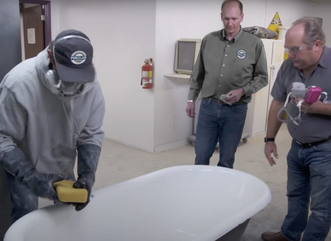 Refinishing expert applying safety gear before reglazing tile in a Revere bathroom