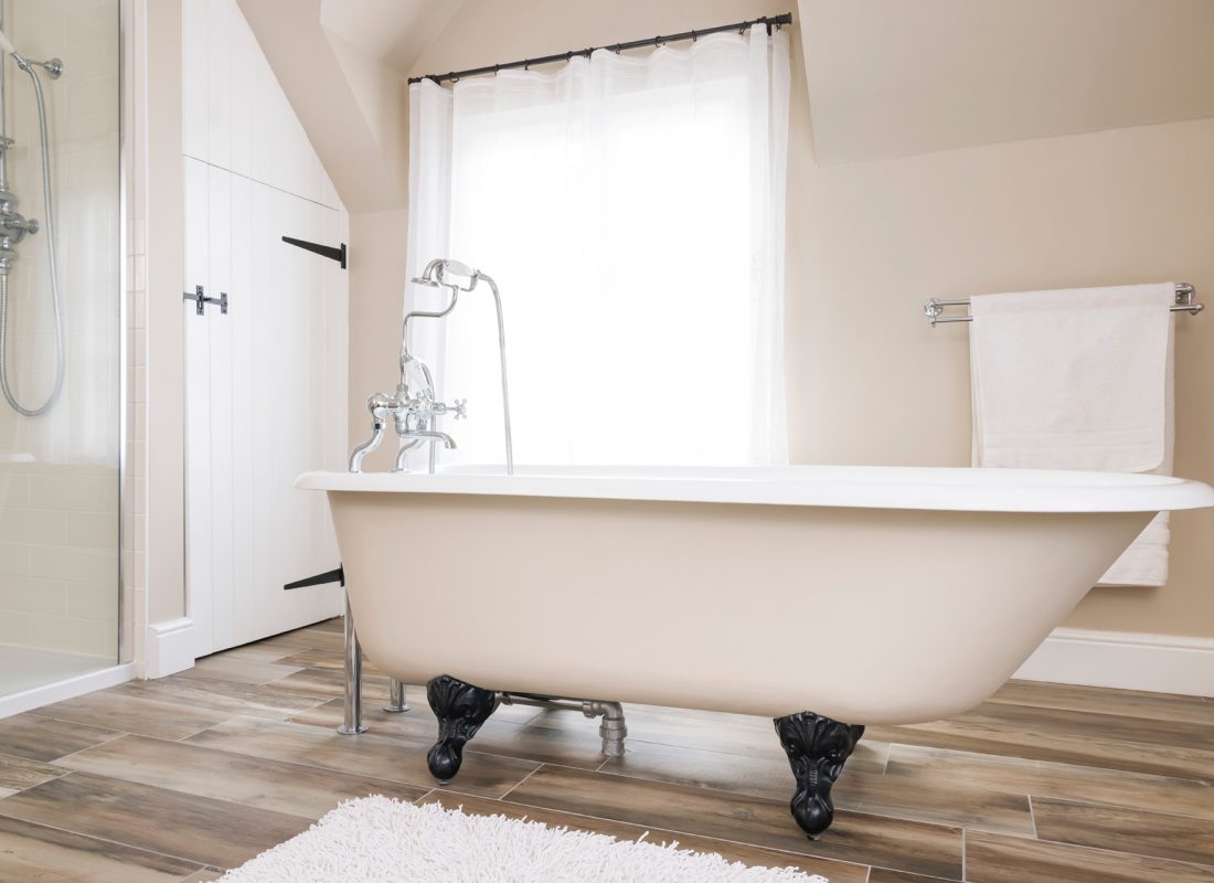 Porcelain Patch & Glaze team expertly applying coatings during a bathroom tub refinishing service in Middlesex County